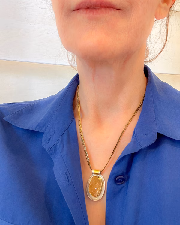 SC009 Sugar Sunbeams druzy pendant model 4x5 Gold druzy crystal pendant on model with blue shirt