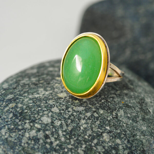 SC012 Chrysoprase Cocktail Ring web 1x1 Gold cocktail ring with green chrysoprase gemstone resting on a grey stone