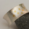 gold confetti on textured silver cuff