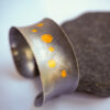 Silver cuff bracelet with gold circles