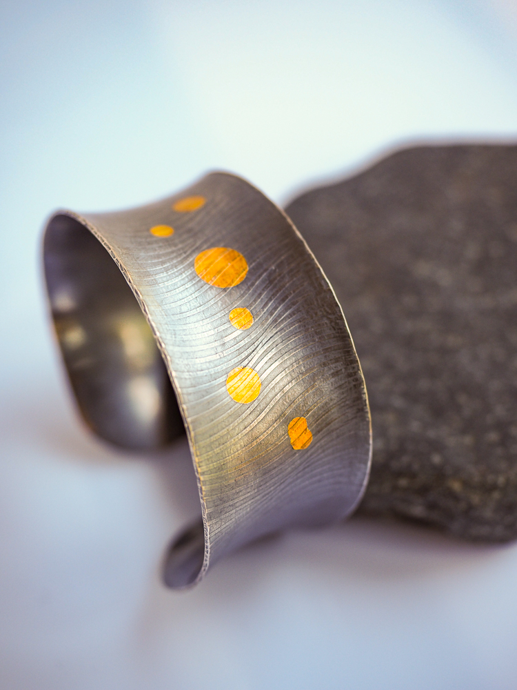 Silver cuff bracelet with gold circles