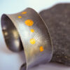 Silver cuff bracelet with gold circles