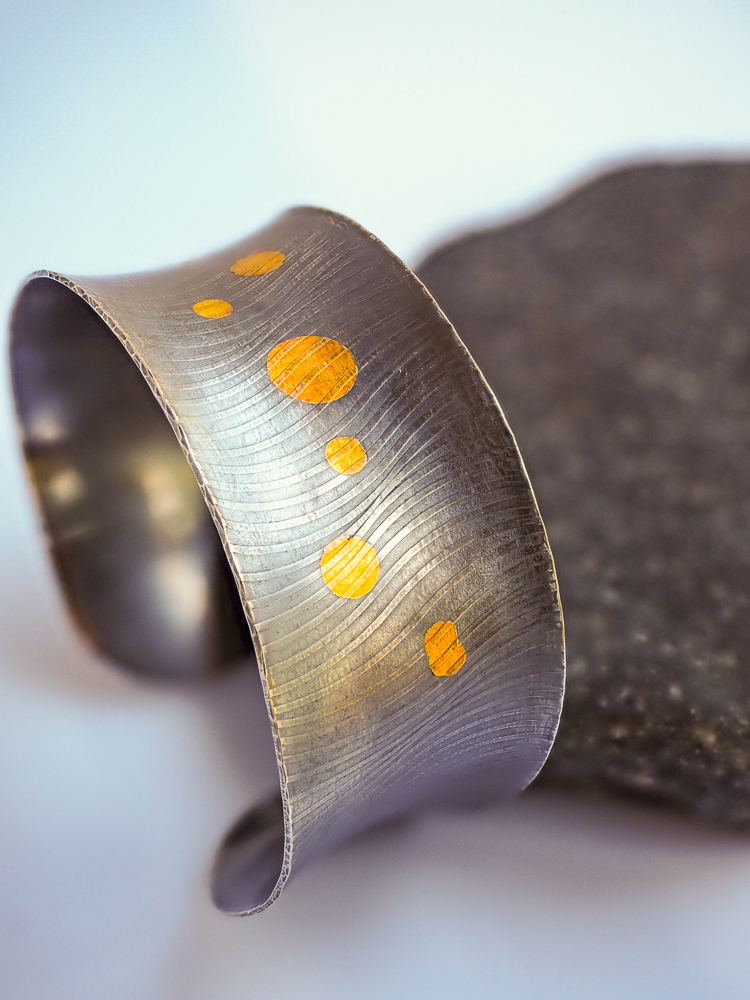 Silver cuff bracelet with gold circles