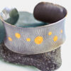 Silver cuff bracelet with gold circles