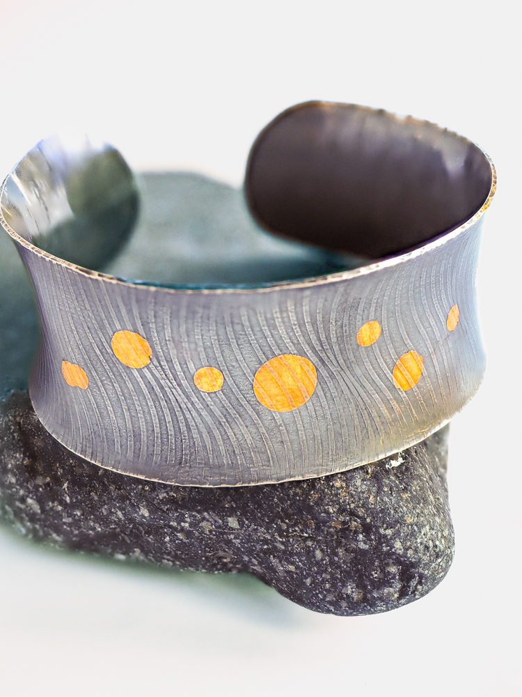 Silver cuff bracelet with gold circles