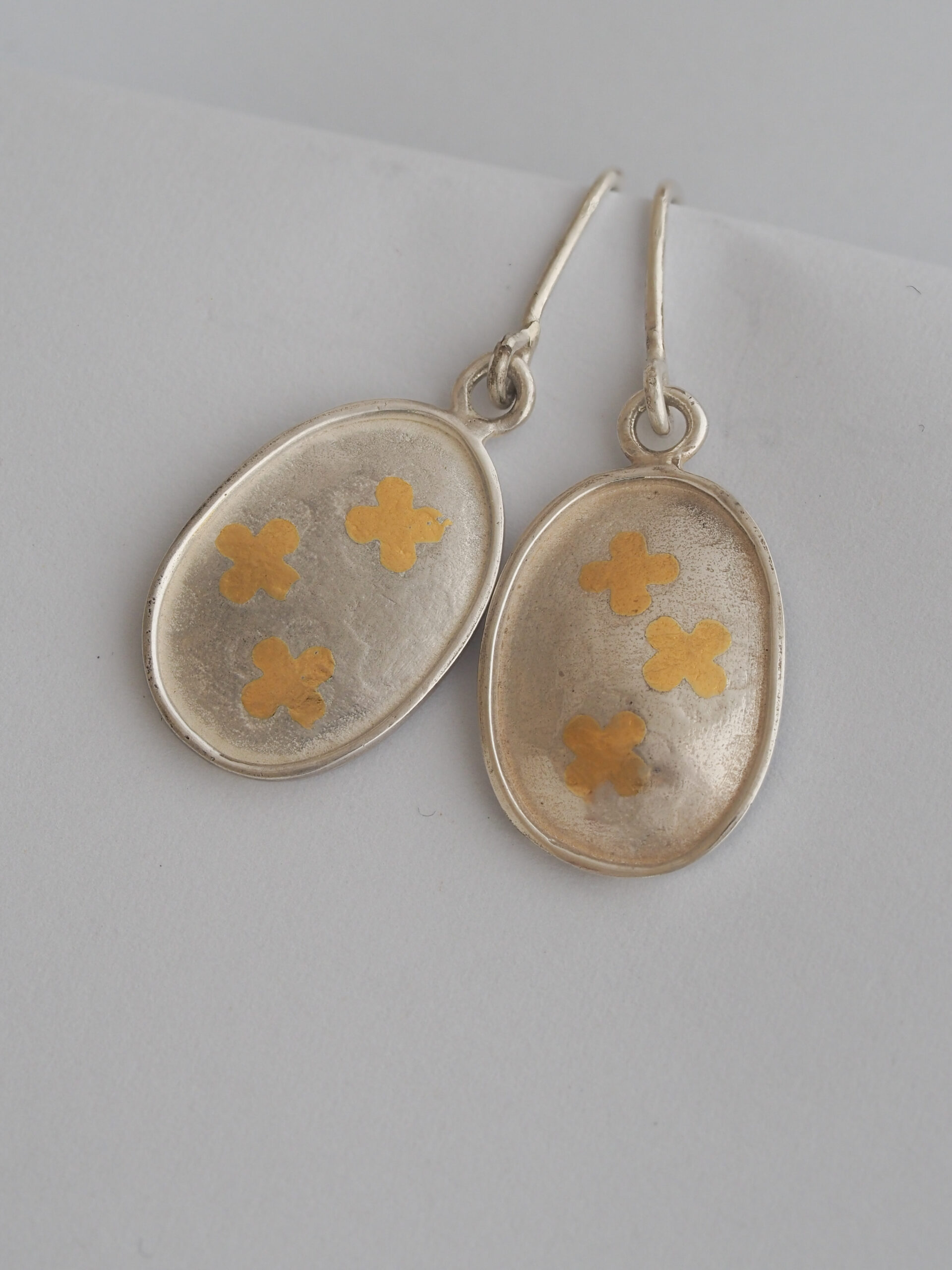 drop earrings with gold clovers