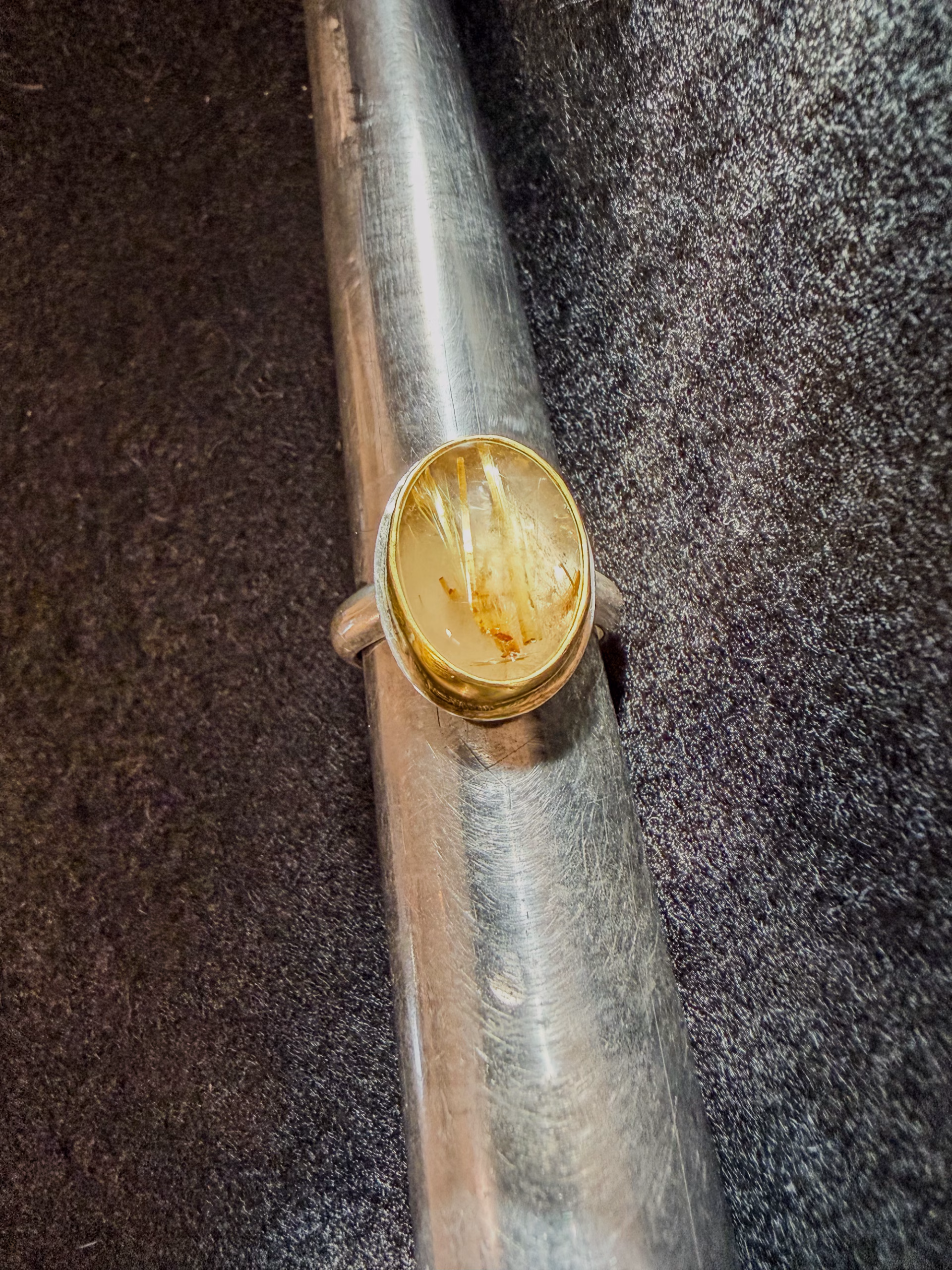 22k gold oval rutilated quartz ring on ring mandrel