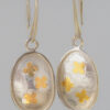 Fortune's Daughter Drop Earrings with gold and silver clover pattern