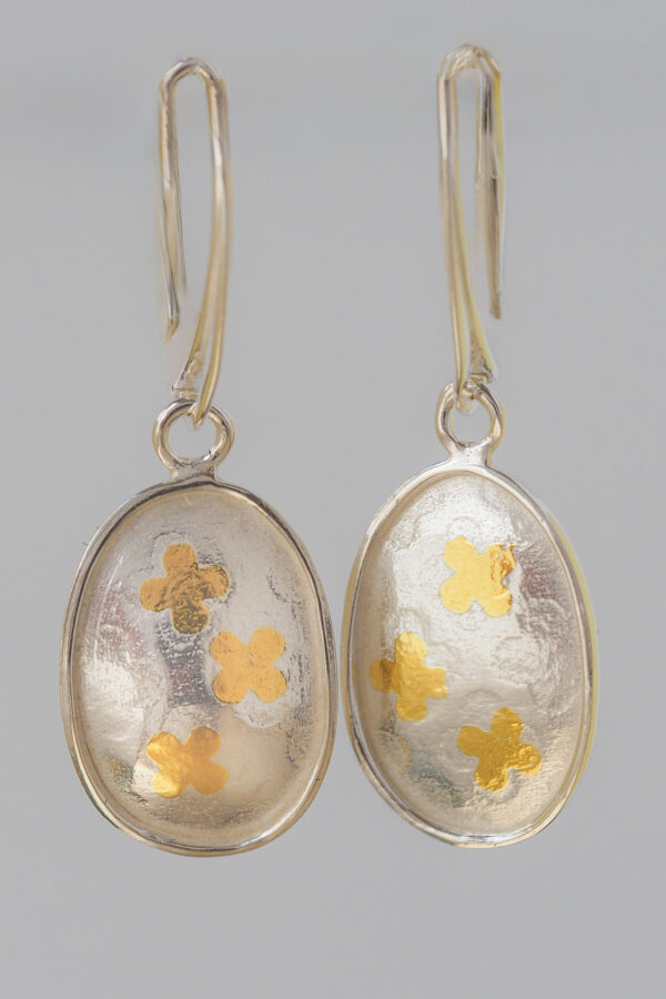 Fortune's Daughter Drop Earrings with gold and silver clover pattern